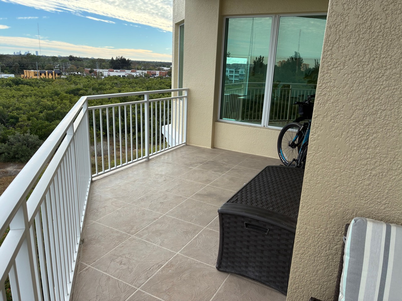 Clean balcony tile with railing and city view