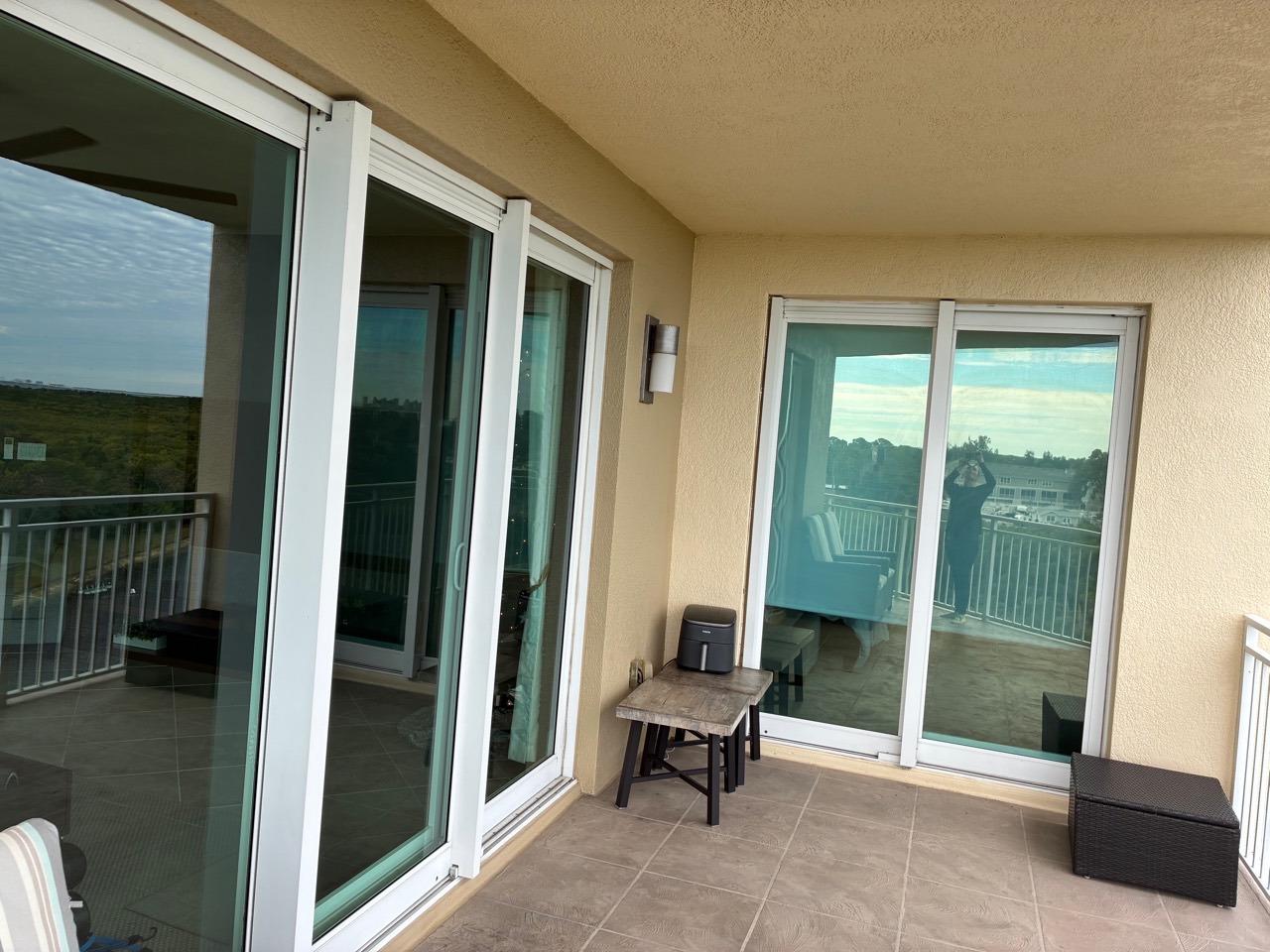 Clean balcony with sliding glass doors and tile floor
