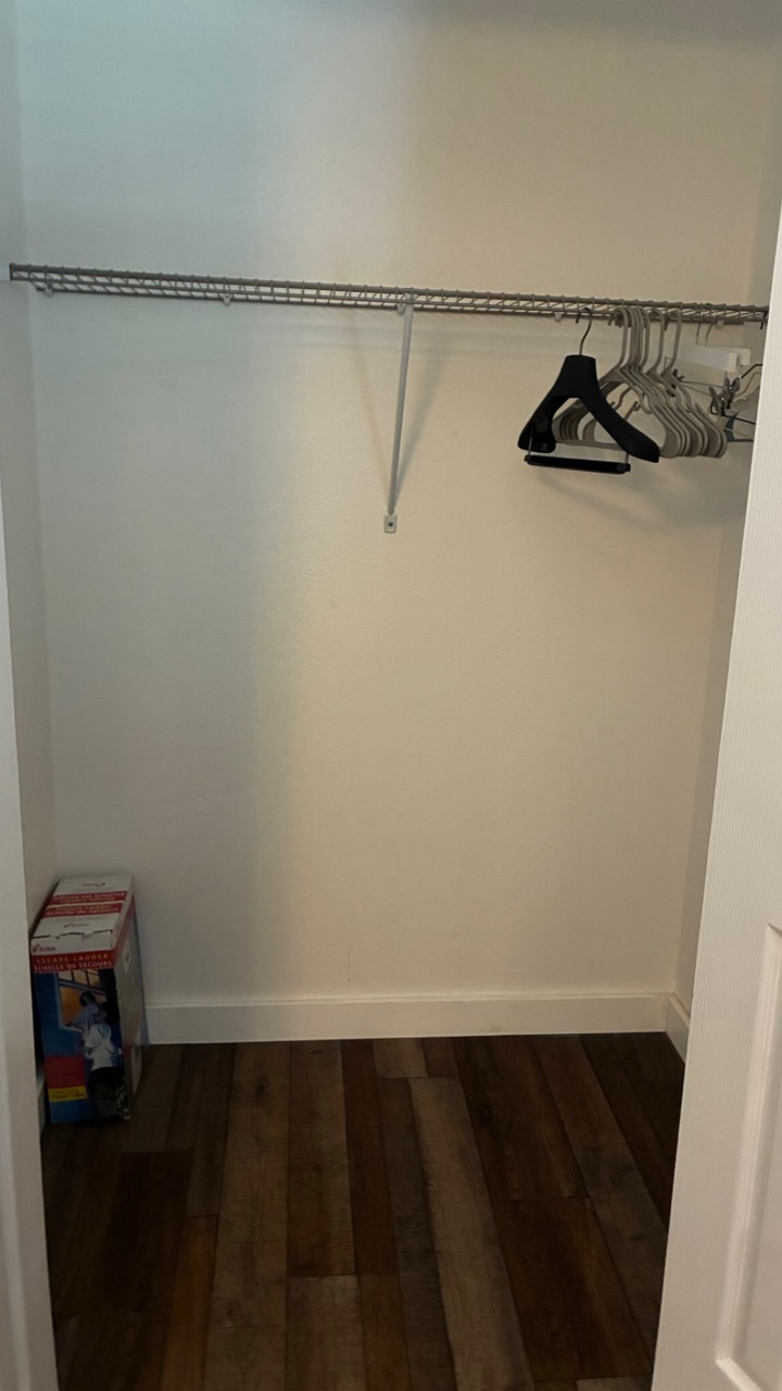 Clean closet with wire shelf and wood-look floor