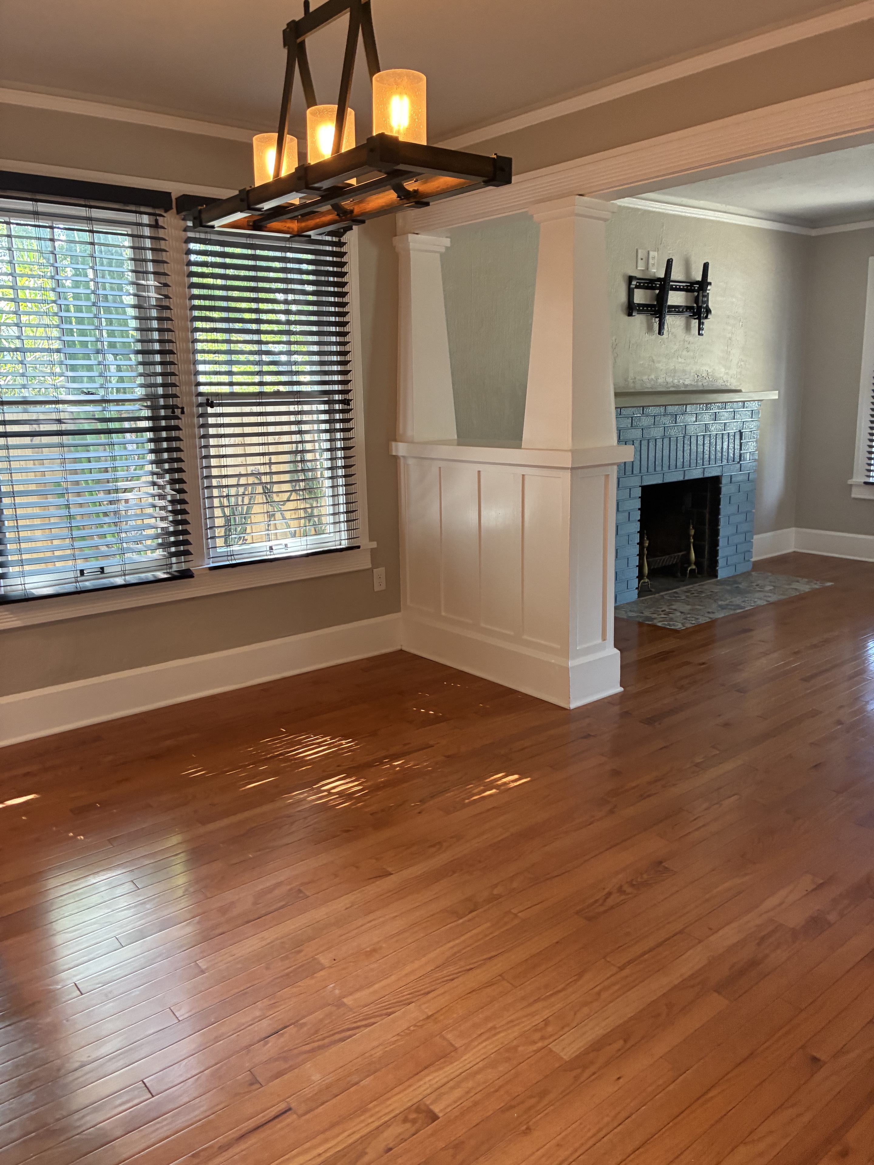 Clean dining and living area with polished hardwood floors