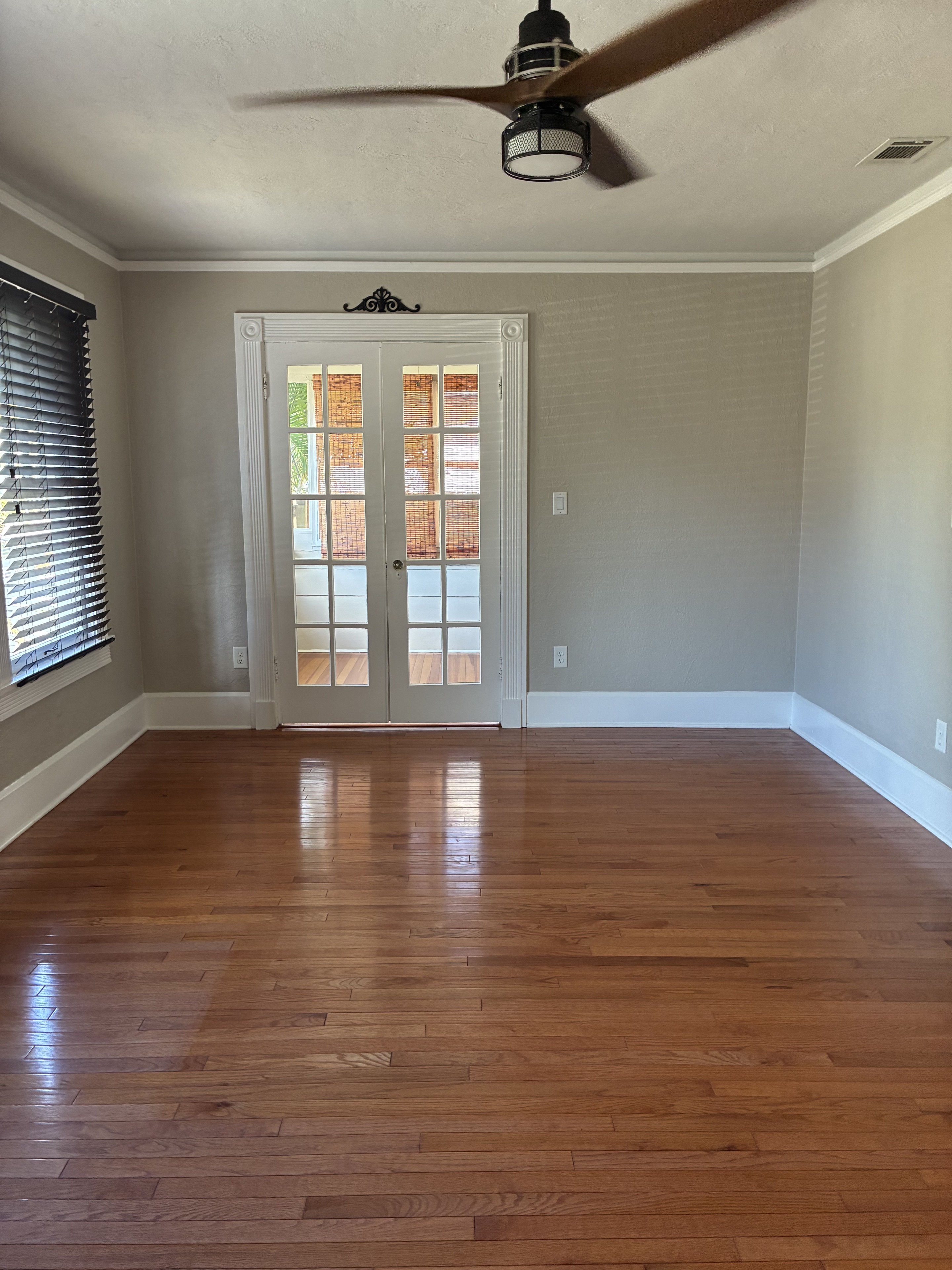 Clean room with French doors and glossy hardwood floors