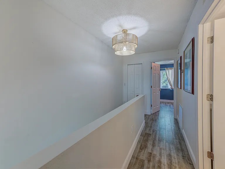 Clean upstairs hallway with wood-look flooring