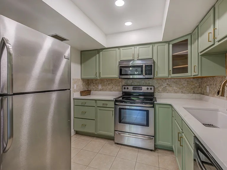 Polished kitchen appliances and counters after cleaning