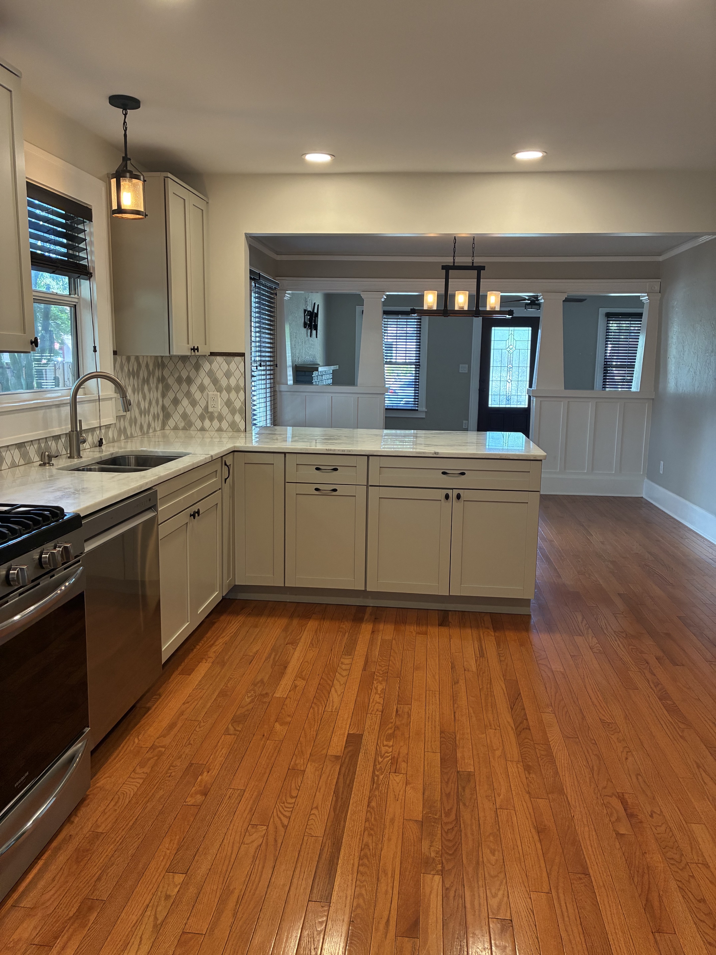 Clean kitchen with polished hardwood floor and island
