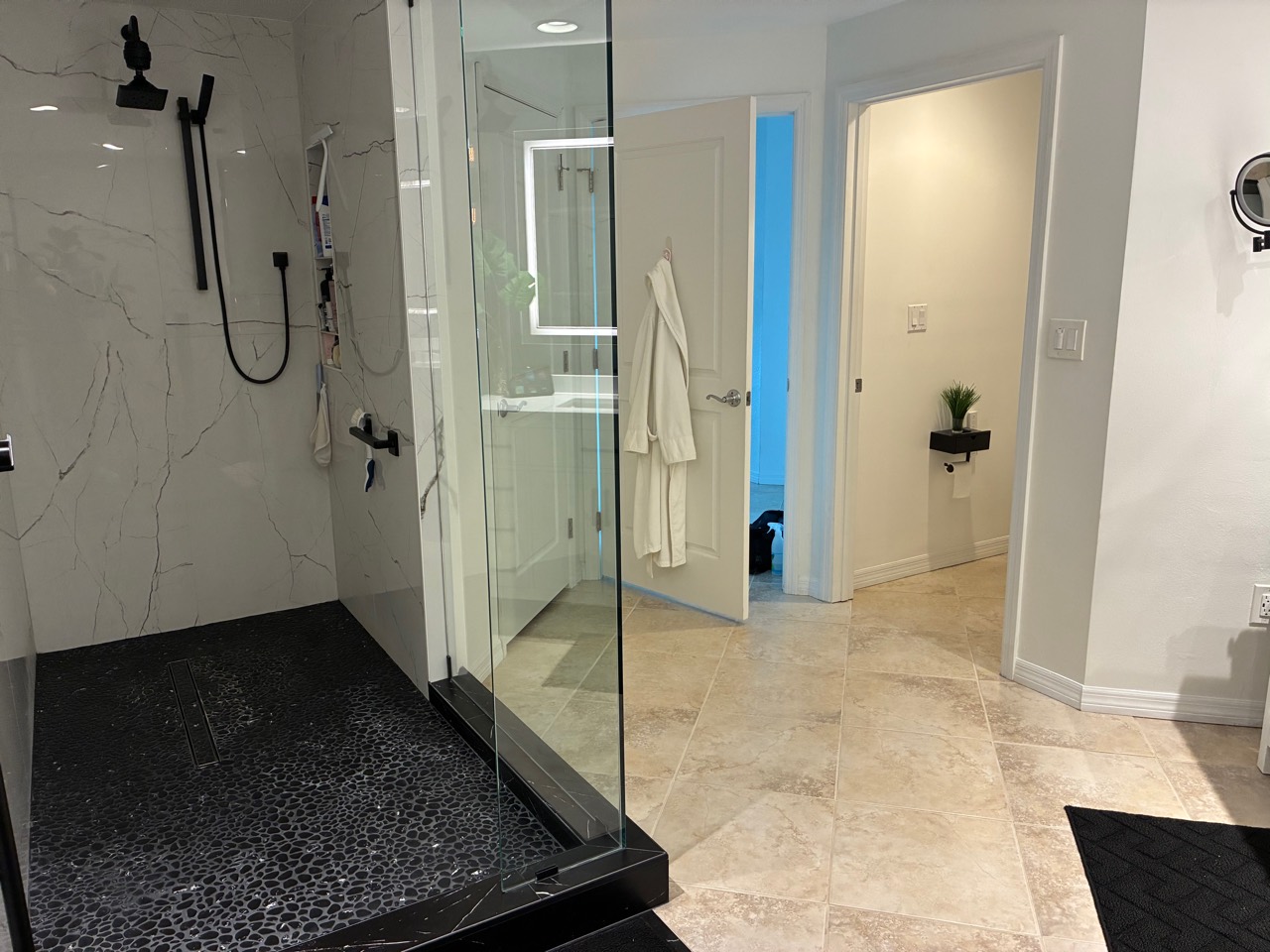 Clean walk-in shower and bathroom tile floor