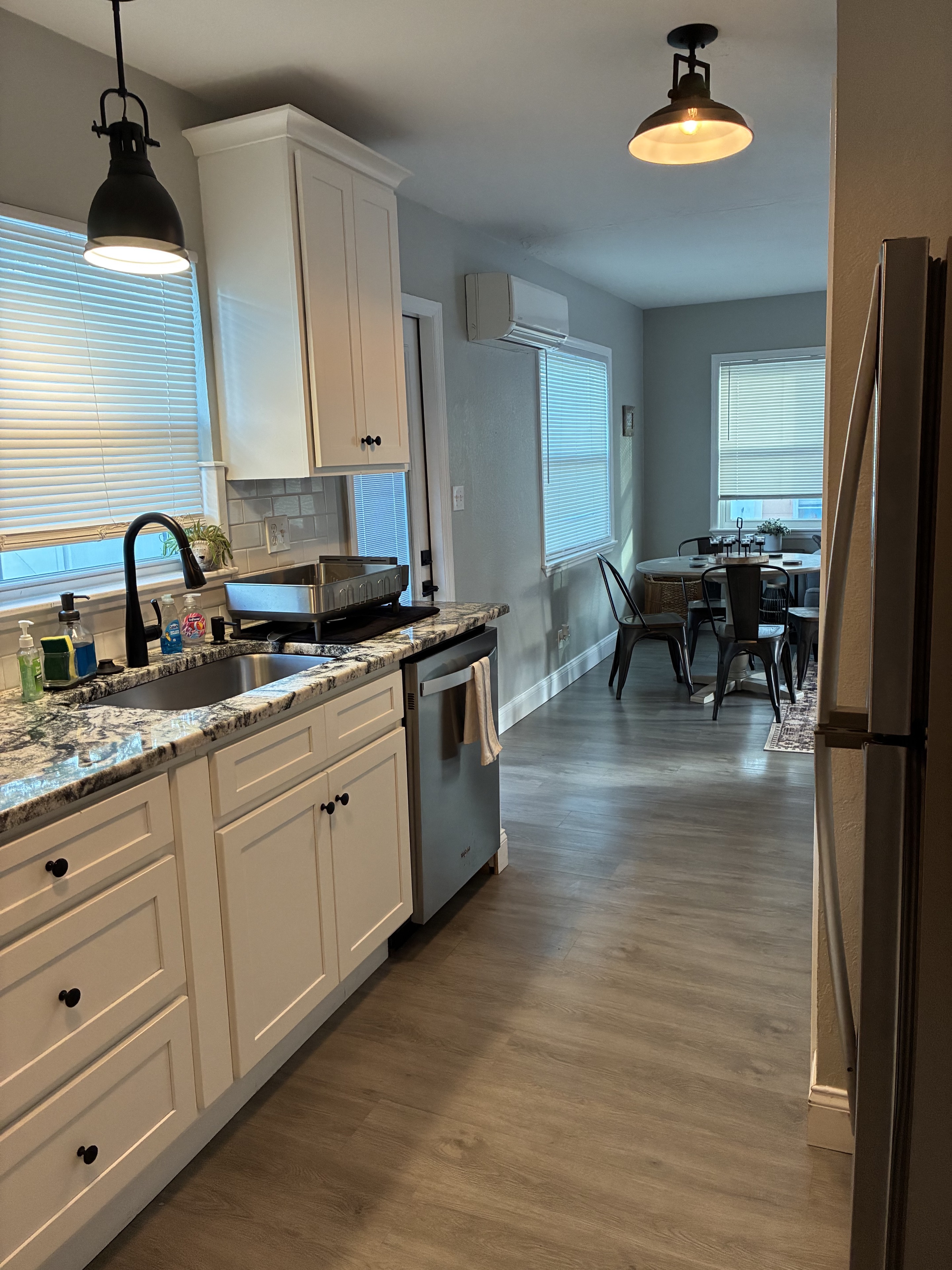 Clean modern kitchen with dining nook and gray flooring
